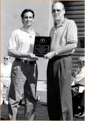 Black and White Photo of Neil Giuliano and Bill Scheid with Award for Kiwanis Tempe Nuevo Playground Project.