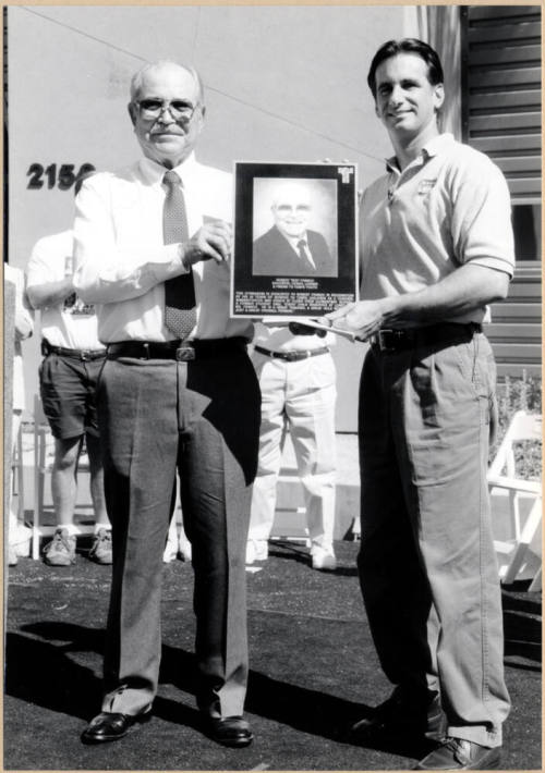 Black and White Photo of Neil Giuliano Presenting Plaque to Robert Franco Dedicating New Gymnasium in His Name.