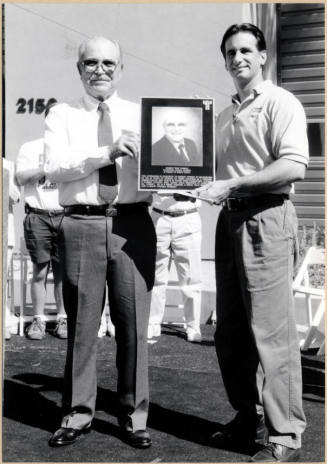 Black and White Photo of Neil Giuliano Presenting Plaque to Robert Franco Dedicating New Gymnasium in His Name.