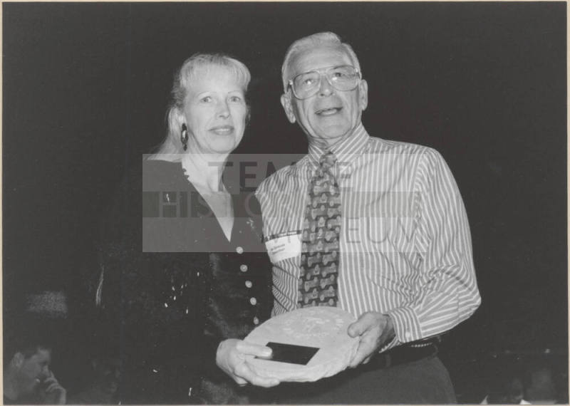 Photo of Joe Spracale Presenting Outgoing Member Plaque to a Woman at Boards and Commissions, 1999.
