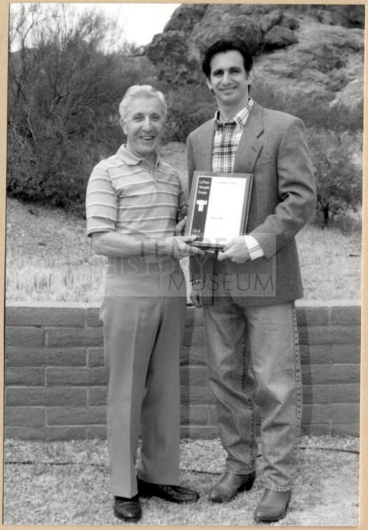 Photo of Neil Giuliano Holding Plaque with Dr. William LoPiano for LoPiano Bosque, Tempe.