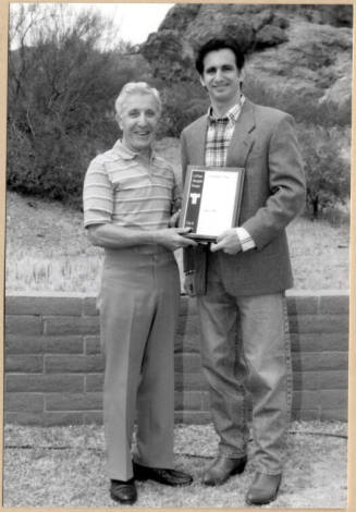 Photo of Neil Giuliano Holding Plaque with Dr. William LoPiano for LoPiano Bosque, Tempe.