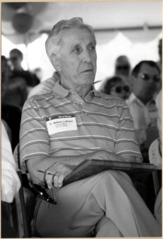 Photo of Dr. William LoPiano Holding Plaque.