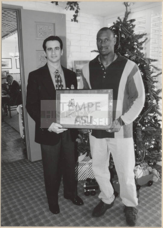 Neil Giuliano Presents Rose Bowl Plaque to Unnamed Man, 1997.