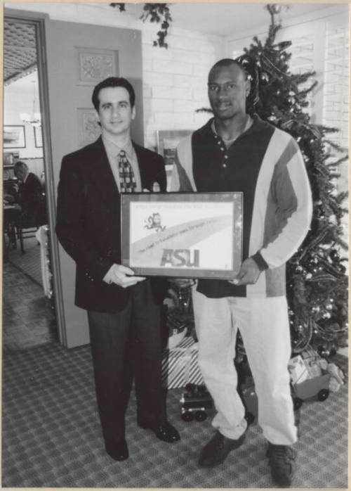 Neil Giuliano Presents Rose Bowl Plaque to Unnamed Man, 1997.