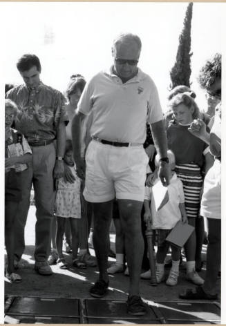 Councilman Frank Plencner Making a Cement Footprint During the Grand Opening of the Tempe Historical Museum, Oct. 1991.