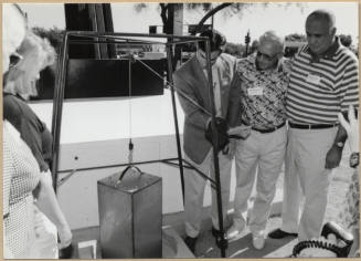 Photo of Mayor Neil Giuliano Lowering Time Capsule Behind Tempe Historical Museum Sign with Councilmembers.