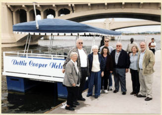 Photo of a group next to the Dottie Cooper Nelson Boat by Mill Ave. Bridge.