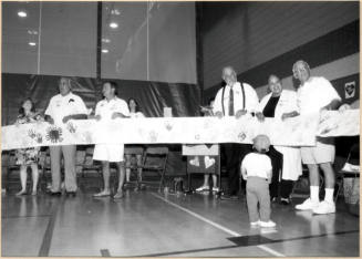 Photo of Stand for Children event speakers holding handprint banner.