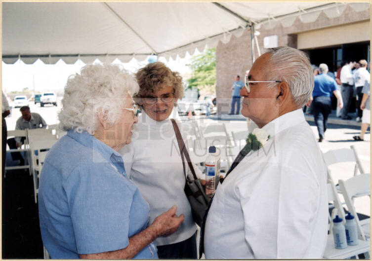 Color photograph shows group standing under reception tent at dedication of Johnny Martinez Water Dept. Treatment Plant.