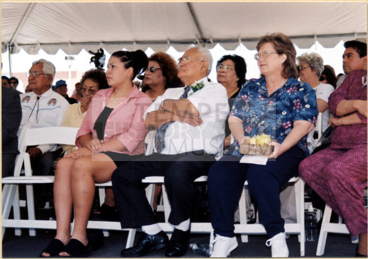 Color photograph of Johnny Martinez with two family members under reception tent at the water treatment plant dedication to Mr. Martinez.