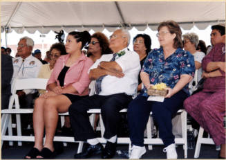Color photograph of Johnny Martinez with two family members under reception tent at the water treatment plant dedication to Mr. Martinez.