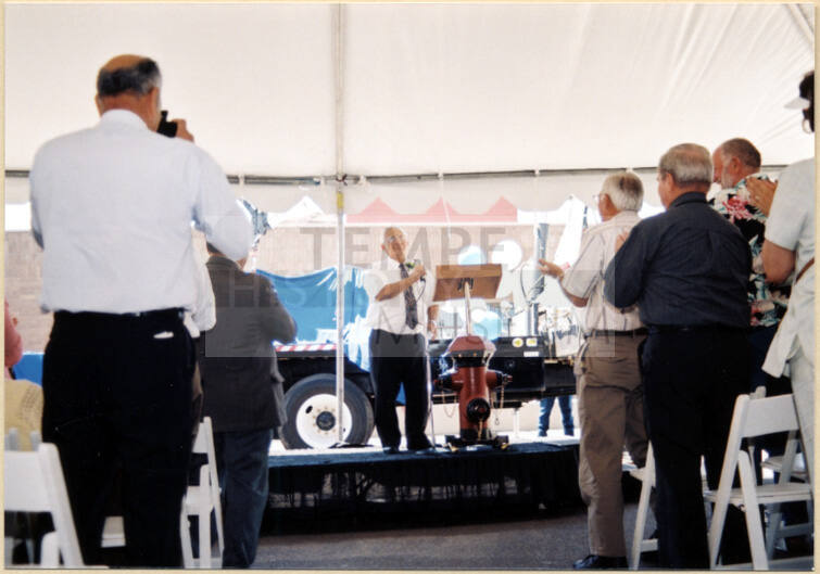 Color photograph of water treatment plant dedication with Johnny Martinez speaking.