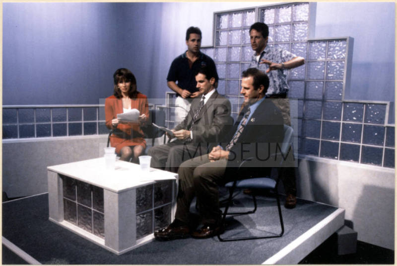 Color photograph of Niel Giuliano and others preparing to appear on local television