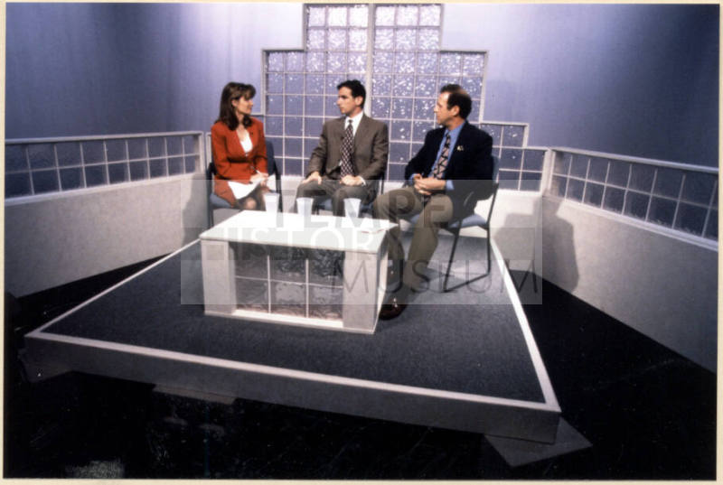 Color photograph of Niel Giuliano and others appearing on local television