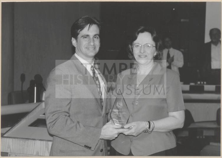 Photograph of Mayor Niel Giulano and woman holding glass trophy