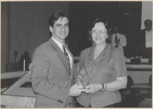 Photograph of Mayor Niel Giulano and woman holding glass trophy