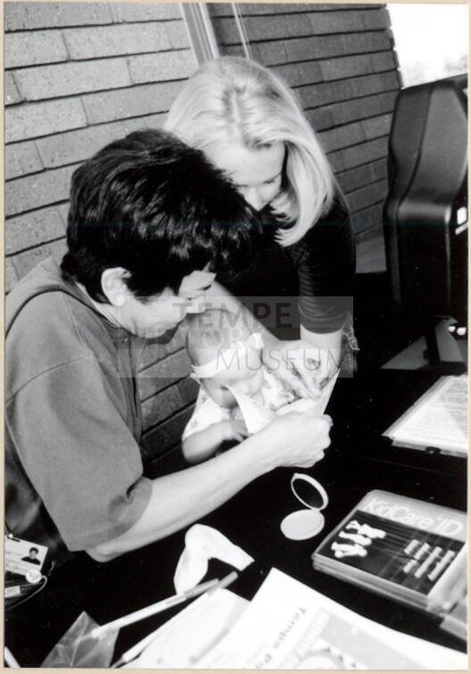 Black and White photograph of baby fingerprinted at Fire Prevention Day