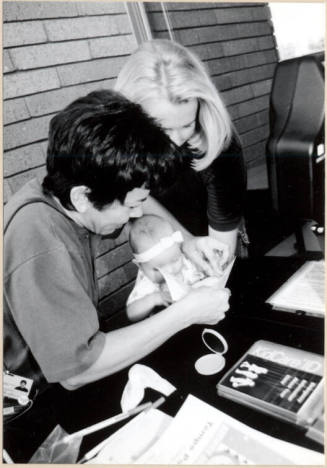 Black and White photograph of baby fingerprinted at Fire Prevention Day