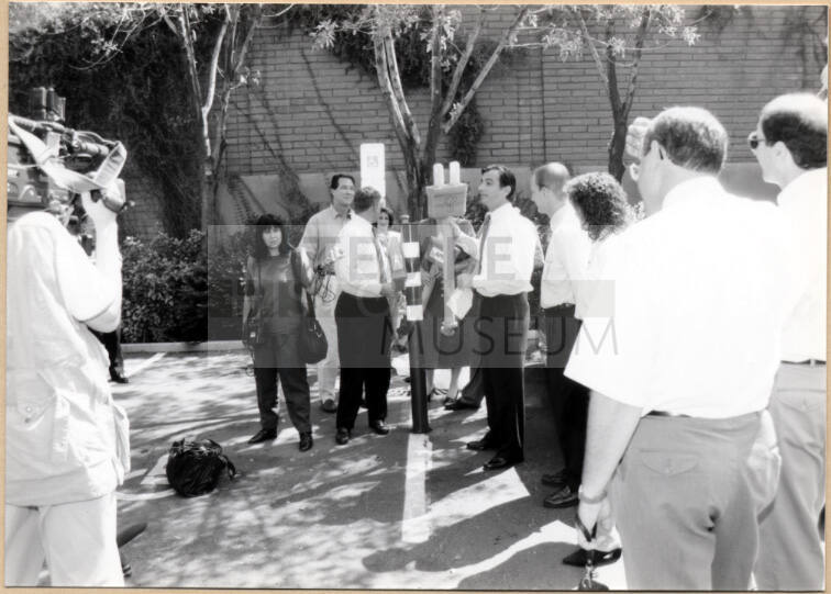 Black and white photograph of Niel Giulano and group at electric vehicle debut