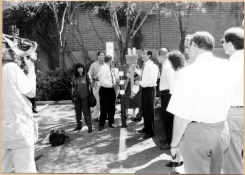 Black and white photograph of Niel Giulano and group at electric vehicle debut