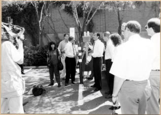 Black and white photograph of Niel Giulano and group at electric vehicle debut