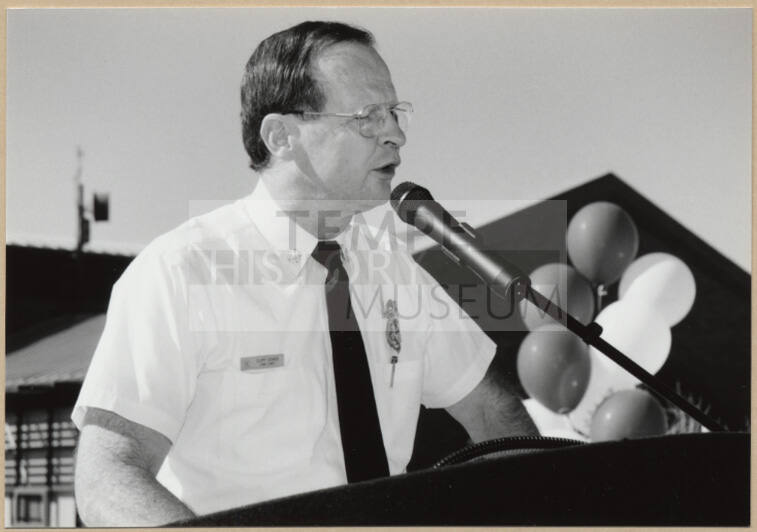 Black and white photograph of Fire Chief Cliff Jones speaking at dedication of Apache Blvd. Fire Station