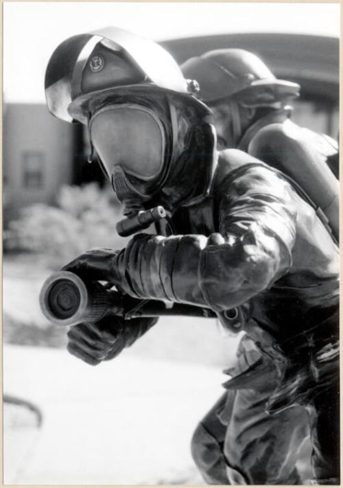 Black and white photograph of fire fighter statue at the dedication of Apache Blvd. Fire Station