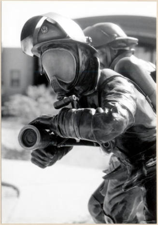 Black and white photograph of fire fighter statue at the dedication of Apache Blvd. Fire Station