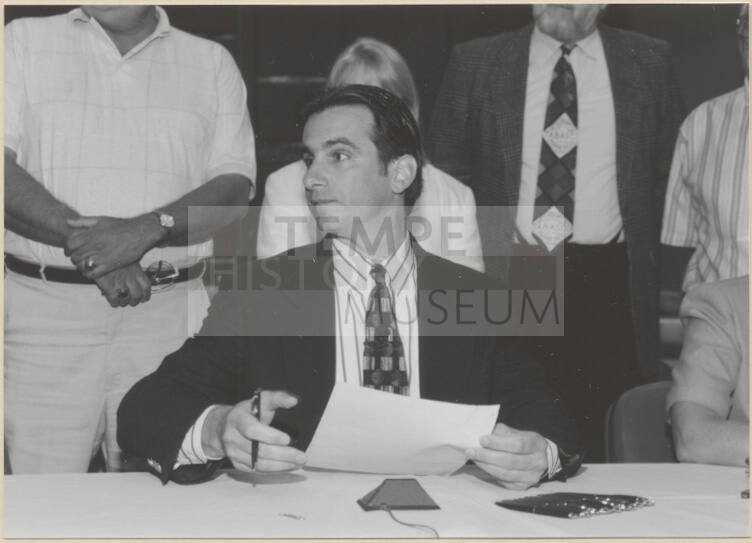 Black and white photograph of Mayor Giuliano at signing of Town Lake Contract