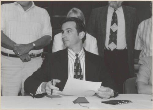 Black and white photograph of Mayor Giuliano at signing of Town Lake Contract