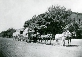 OS-251   Tempe freighter, Jose Araiza, on horseback with a horsedrawn wagon team in front of the Bank of Tempe on Mill Avenue.
