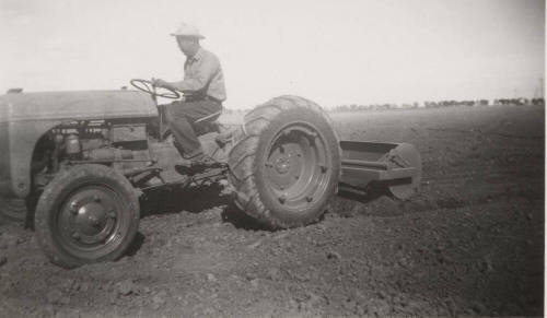 L. Ramsey on Tractor W/ Rollover Scraper