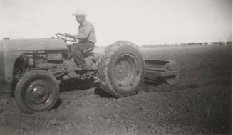 L. Ramsey on Tractor W/ Rollover Scraper