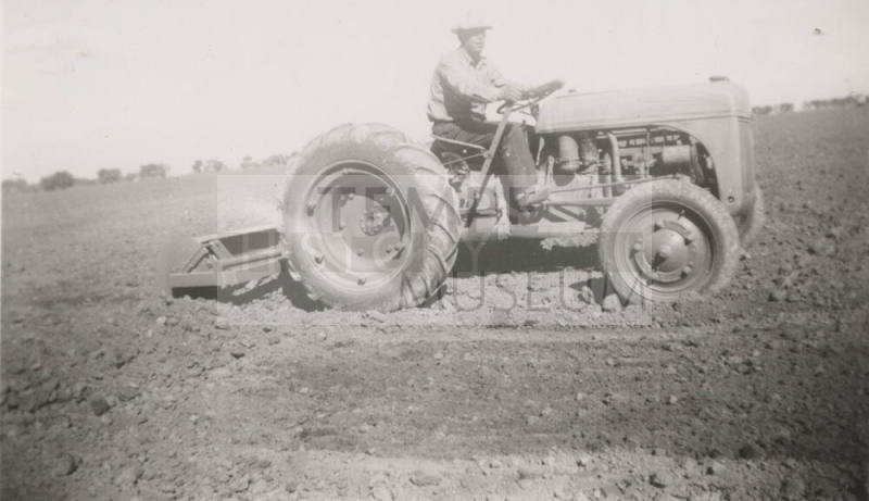 L. Ramsey on Tractor W/ Rollover Scraper