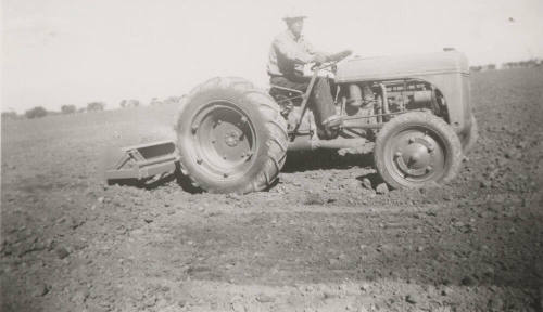 L. Ramsey on Tractor W/ Rollover Scraper