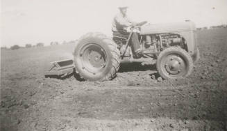 L. Ramsey on Tractor W/ Rollover Scraper