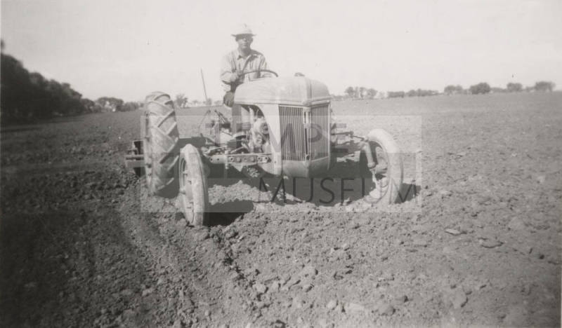 L. Ramsey on Tractor W/ Rollover Scraper