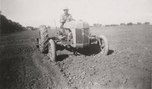 L. Ramsey on Tractor W/ Rollover Scraper