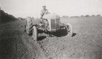 L. Ramsey on Tractor W/ Rollover Scraper