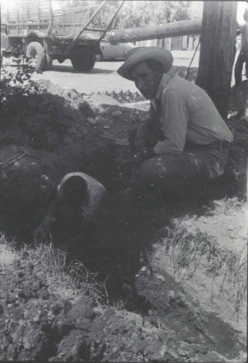 Workmen Dig Streeside Trench