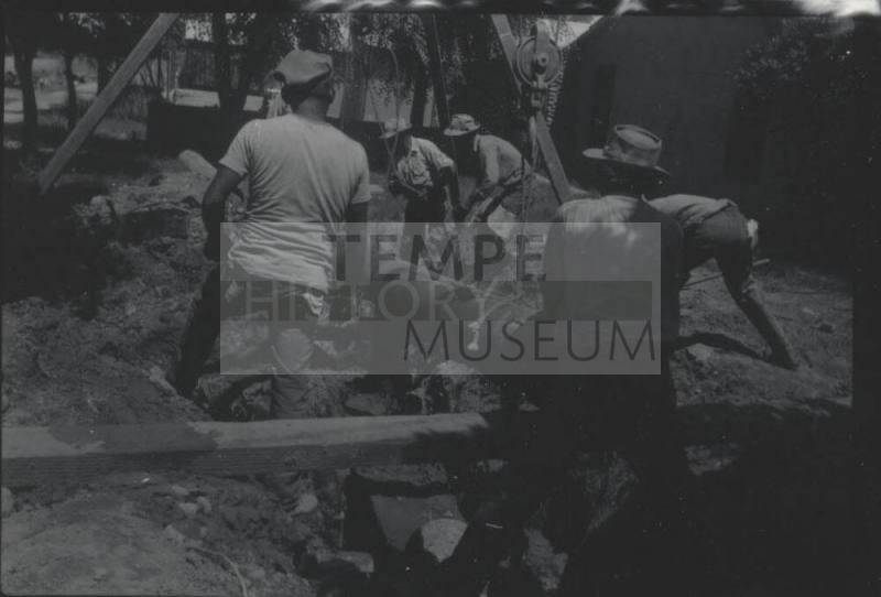 Workmen Use Frame + Pulley to Lay Pipe