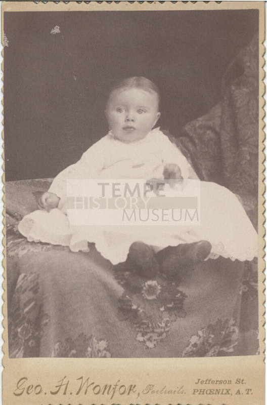 Sitting Child, White Cloths and Pin
