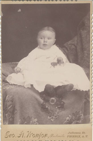 Sitting Child, White Cloths and Pin