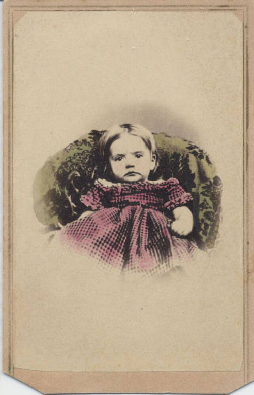 Child Sitting with Checker Dress On