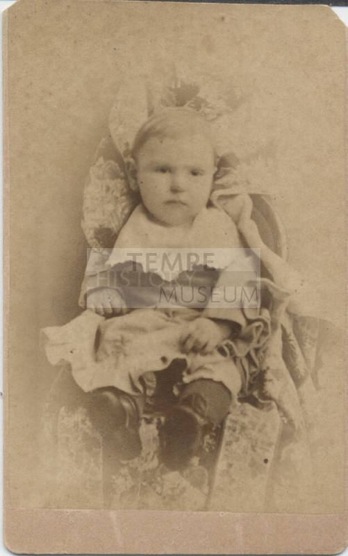 Child Sitting in Dress Clothes