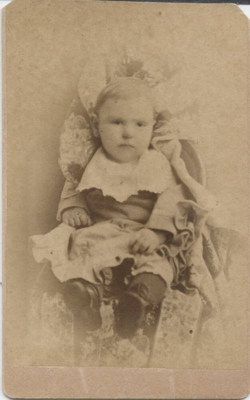 Child Sitting in Dress Clothes