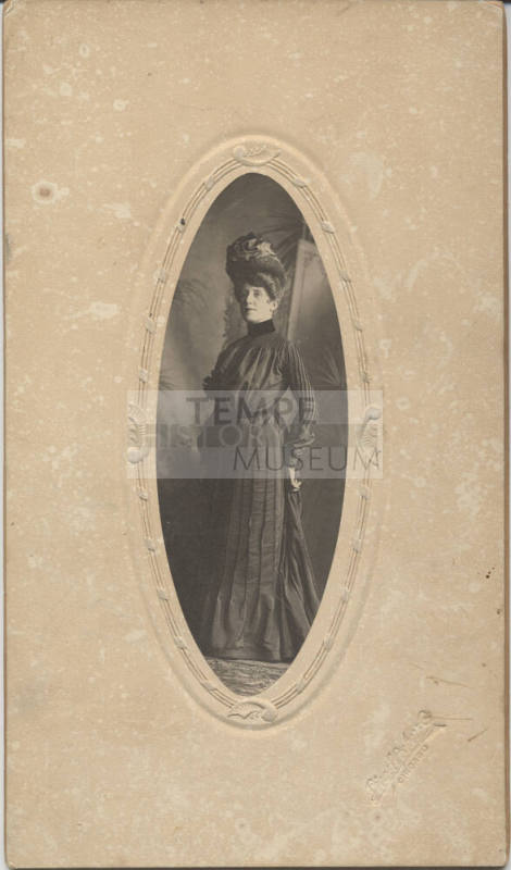 Standing, Woman, Dark Dress and a Hat