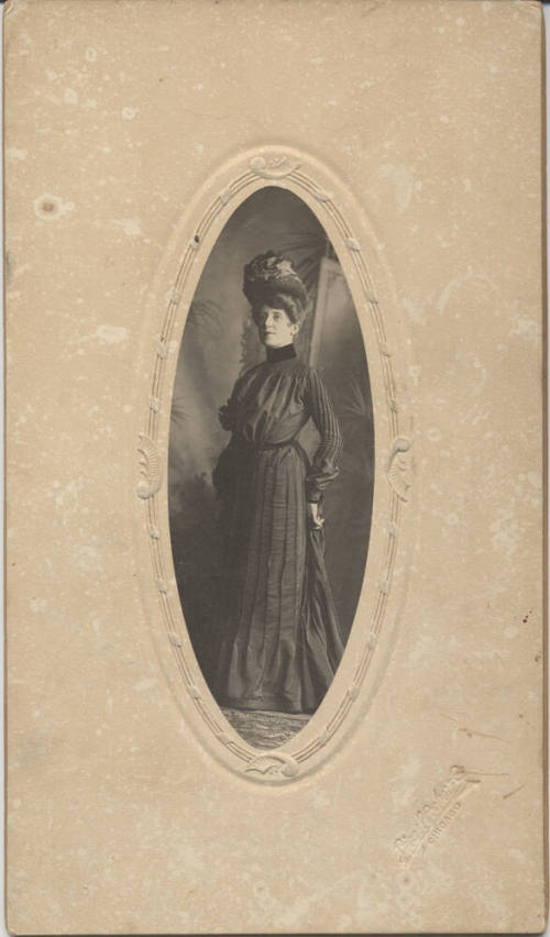 Standing, Woman, Dark Dress and a Hat