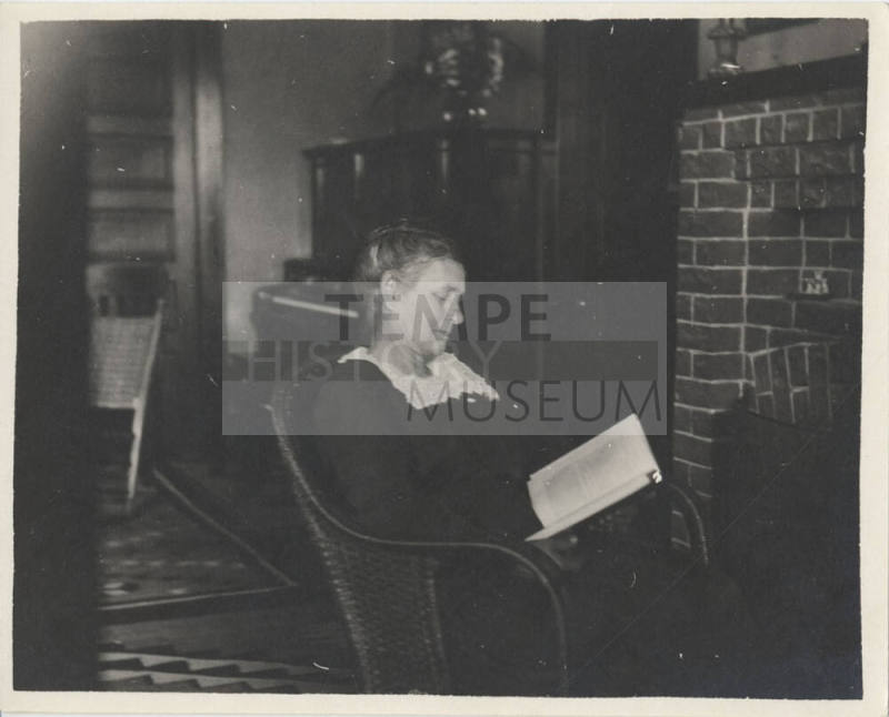 Woman Sitting by Fireplace Reading